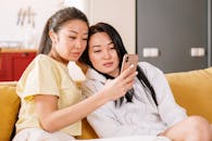 Woman in White Shirt Beside Woman in Beige Shirt