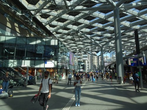 Free Bustling interior of The Hague railway station highlighting modern architecture and daily commuters. Stock Photo
