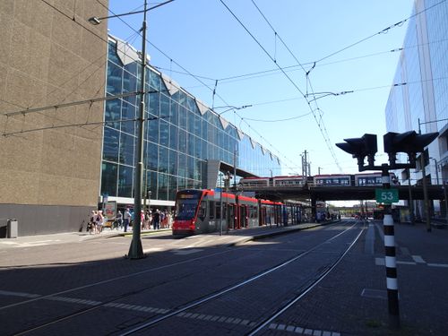 Free A red tram passing in The Hague, Netherlands, showcasing urban architecture and transportation. Stock Photo