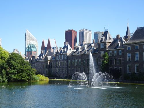 Free Scenic view of the Binnenhof with a water fountain and modern skyline in The Hague. Stock Photo