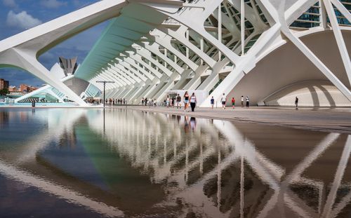 Free Modern architectural landmark in Valencia with tourists and reflections in water. Stock Photo