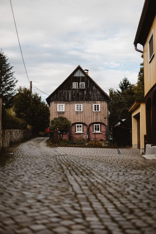 Free Cobblestone street leading to a quaint historic house in Zittau, Saxony, Germany. Stock Photo