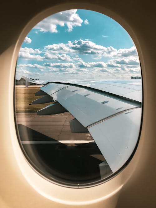 Free Airplane Window Seat View Of White Clouds Stock Photo