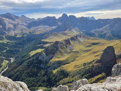 Free Breathtaking aerial view of a vast, green, and rocky mountainous landscape under a cloudy sky. Stock Photo