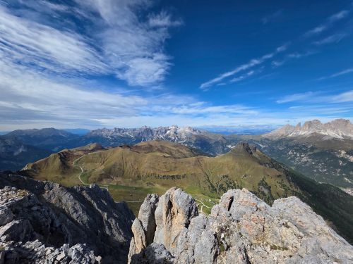 Free Expansive view of the Dolomites under a clear blue sky, showcasing rugged peaks and lush valleys. Stock Photo
