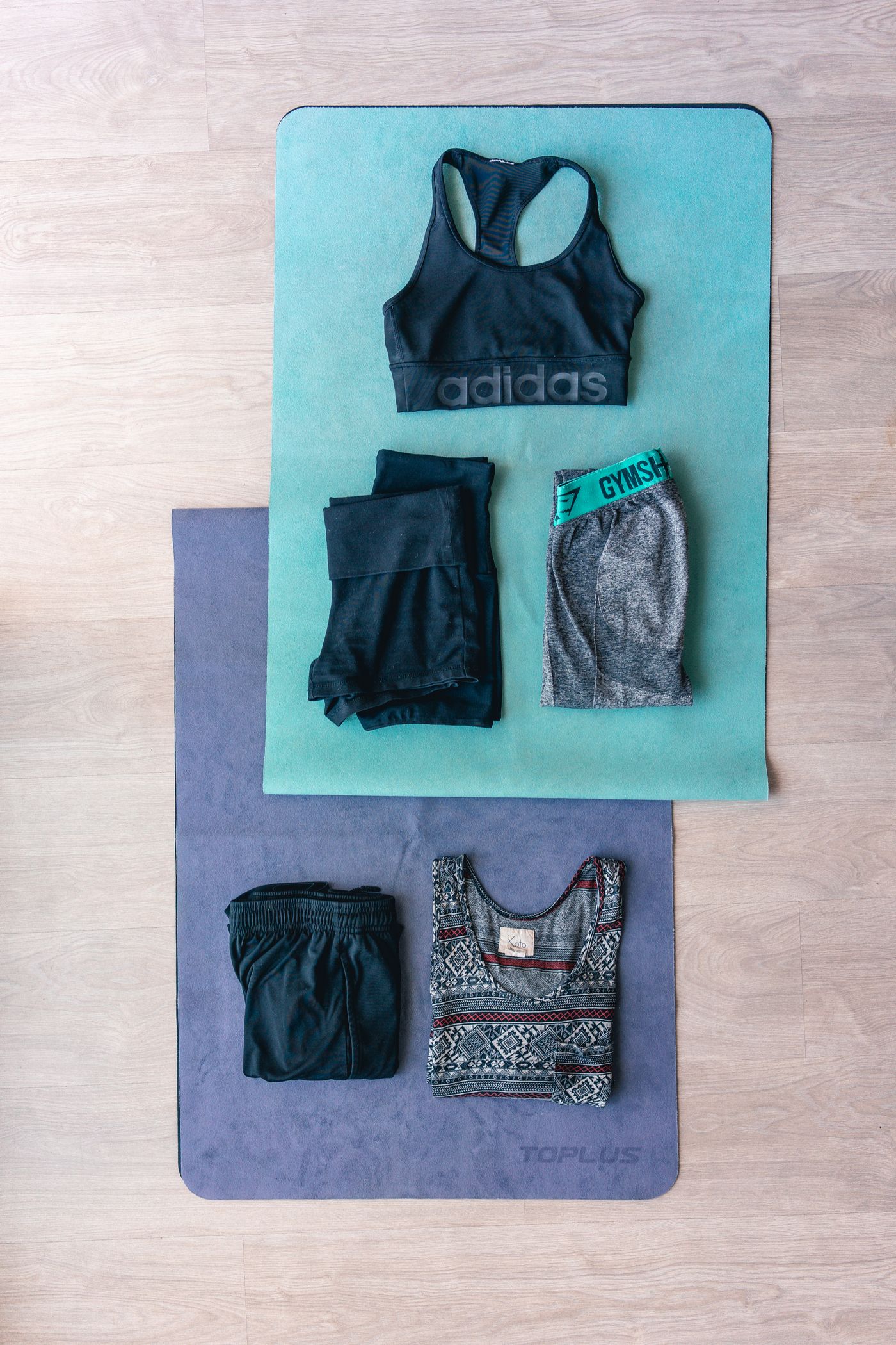 Flat lay of activewear garments and workout textiles