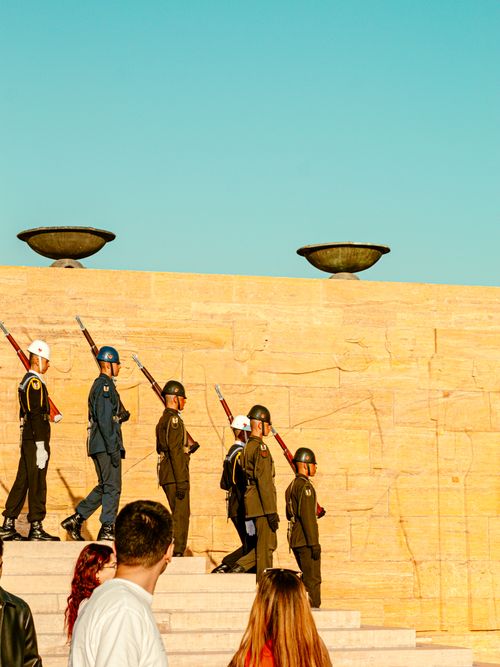 Free Military honor guard in uniform ascending steps at a historical memorial during the day. Stock Photo