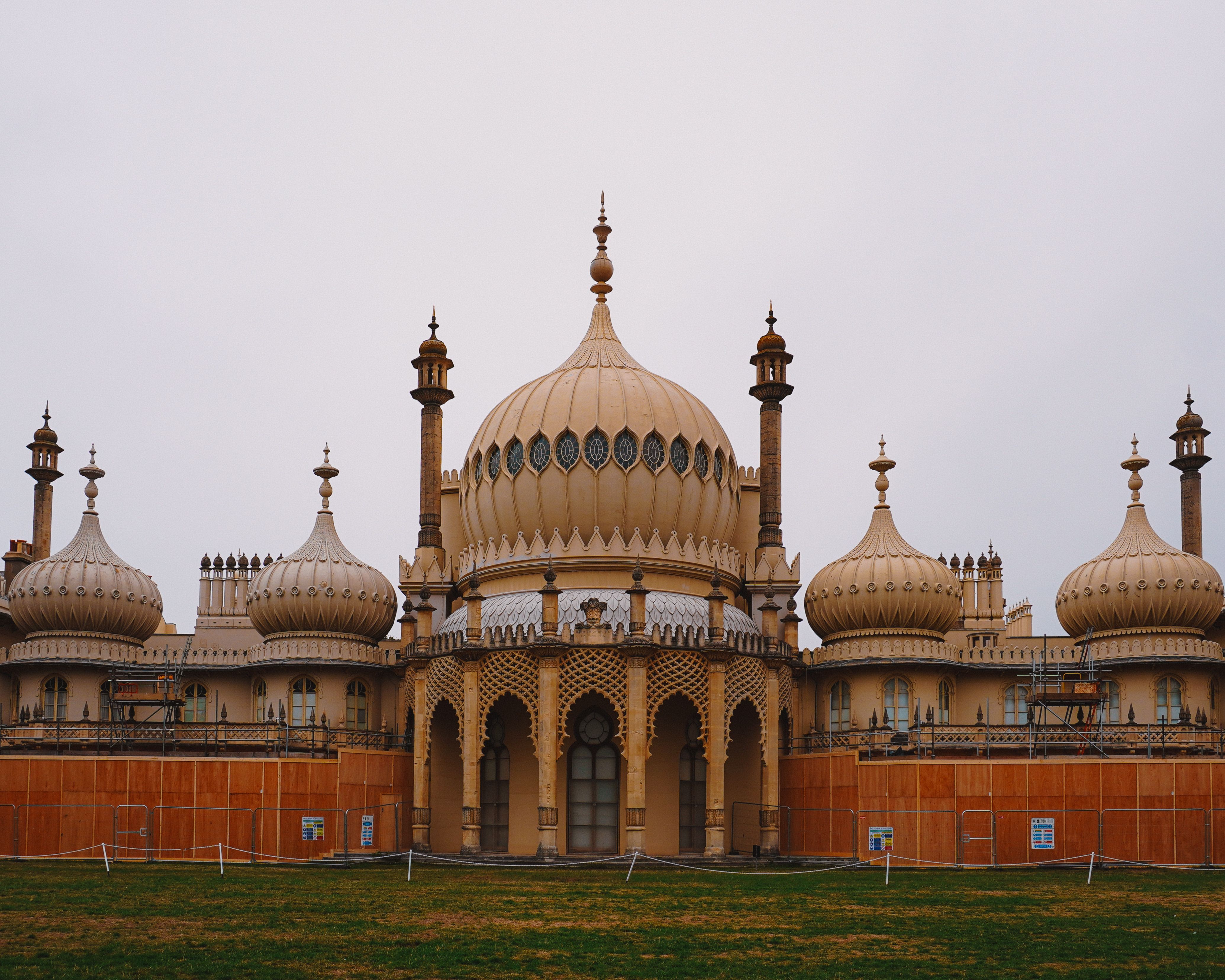 Exterior view of the iconic Royal Pavilion in Brighton, UK. Exotic architectural structure under an overcast sky.