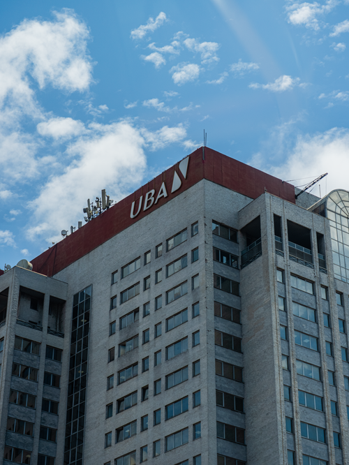 Free A towering office building in Lagos, Nigeria, under a bright blue sky with scattered clouds. Stock Photo