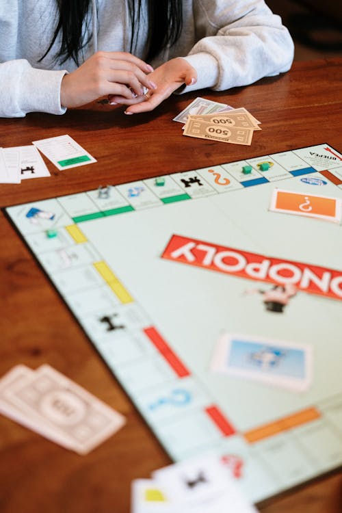 Shallow Focus of Monopoly Board Game on Brown Wooden Surface