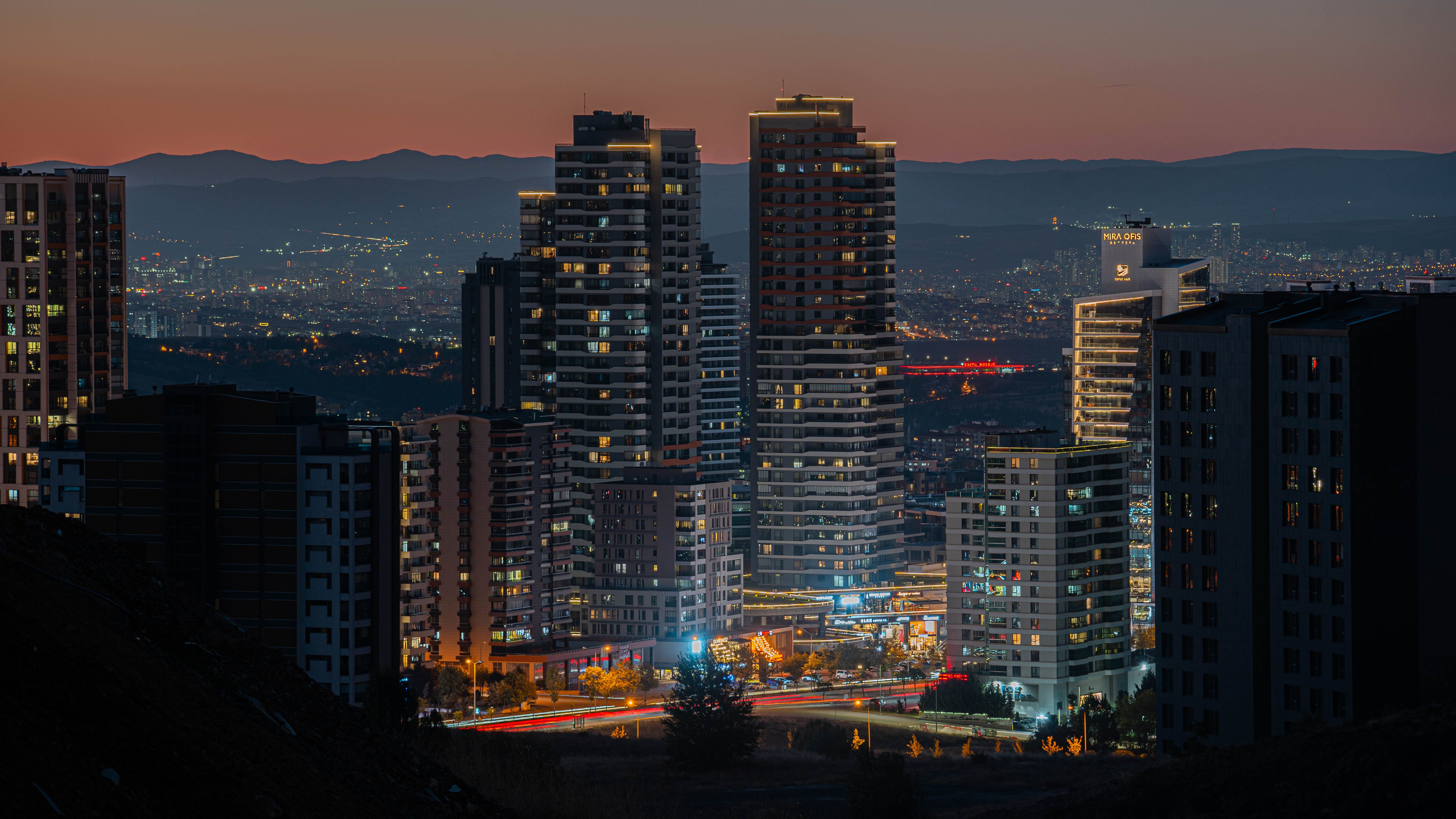 Stunning cityscape of Ankara with illuminated high-rise buildings at twilight.