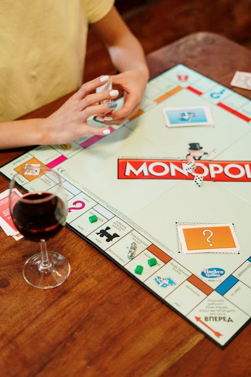 Monopoly Board Game on Brown Wooden Surface 