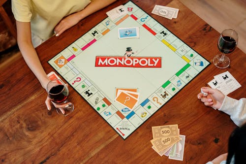 Free Monopoly Board Game on Brown Wooden Table  Stock Photo