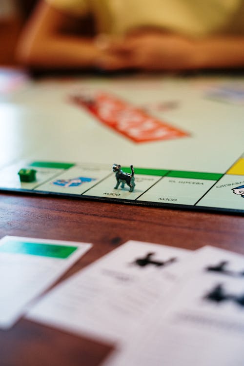 Free Miniature Toy on Monopoly Board Game  Stock Photo