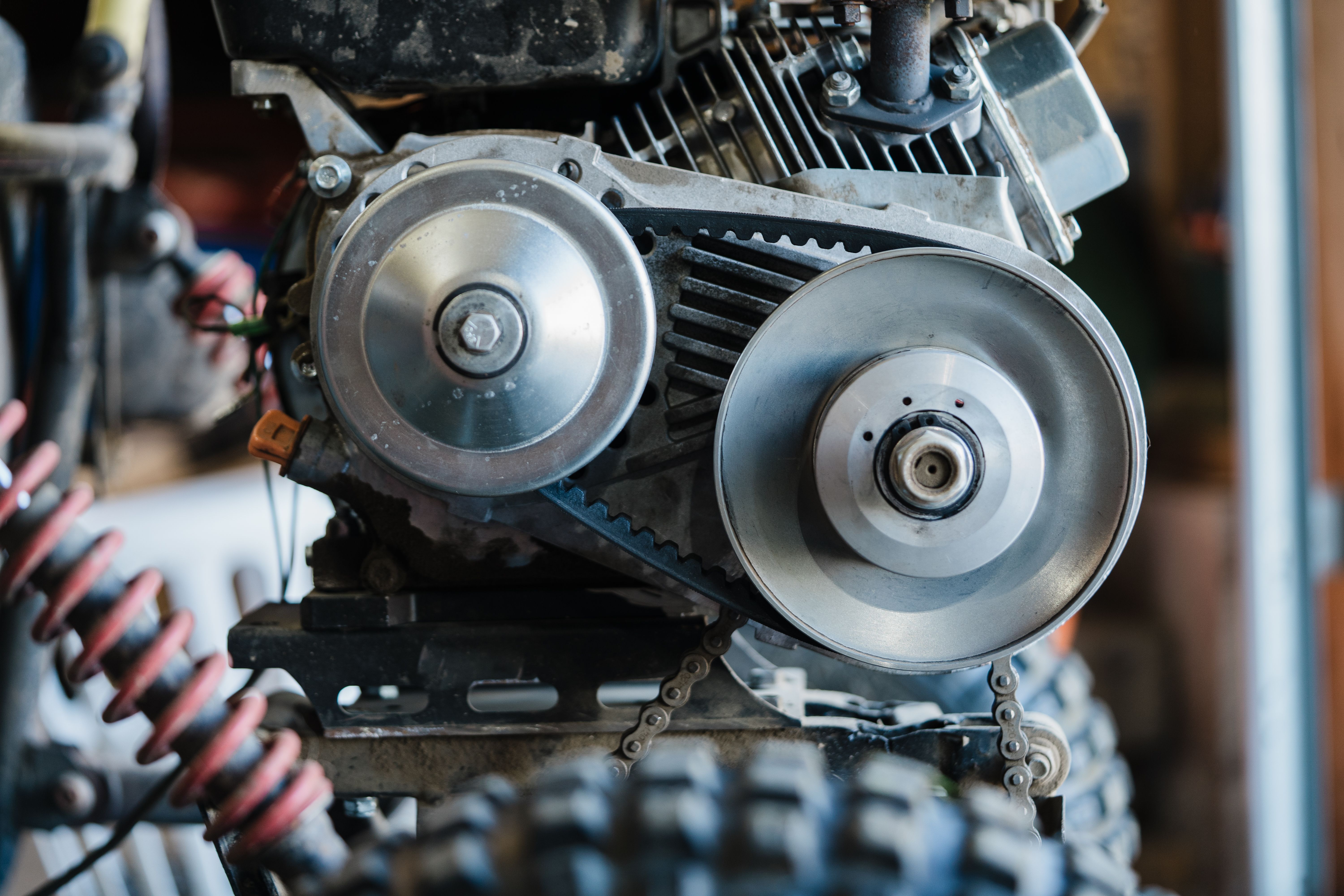 Detailed view of a mechanical assembly showing engine belt and gears.