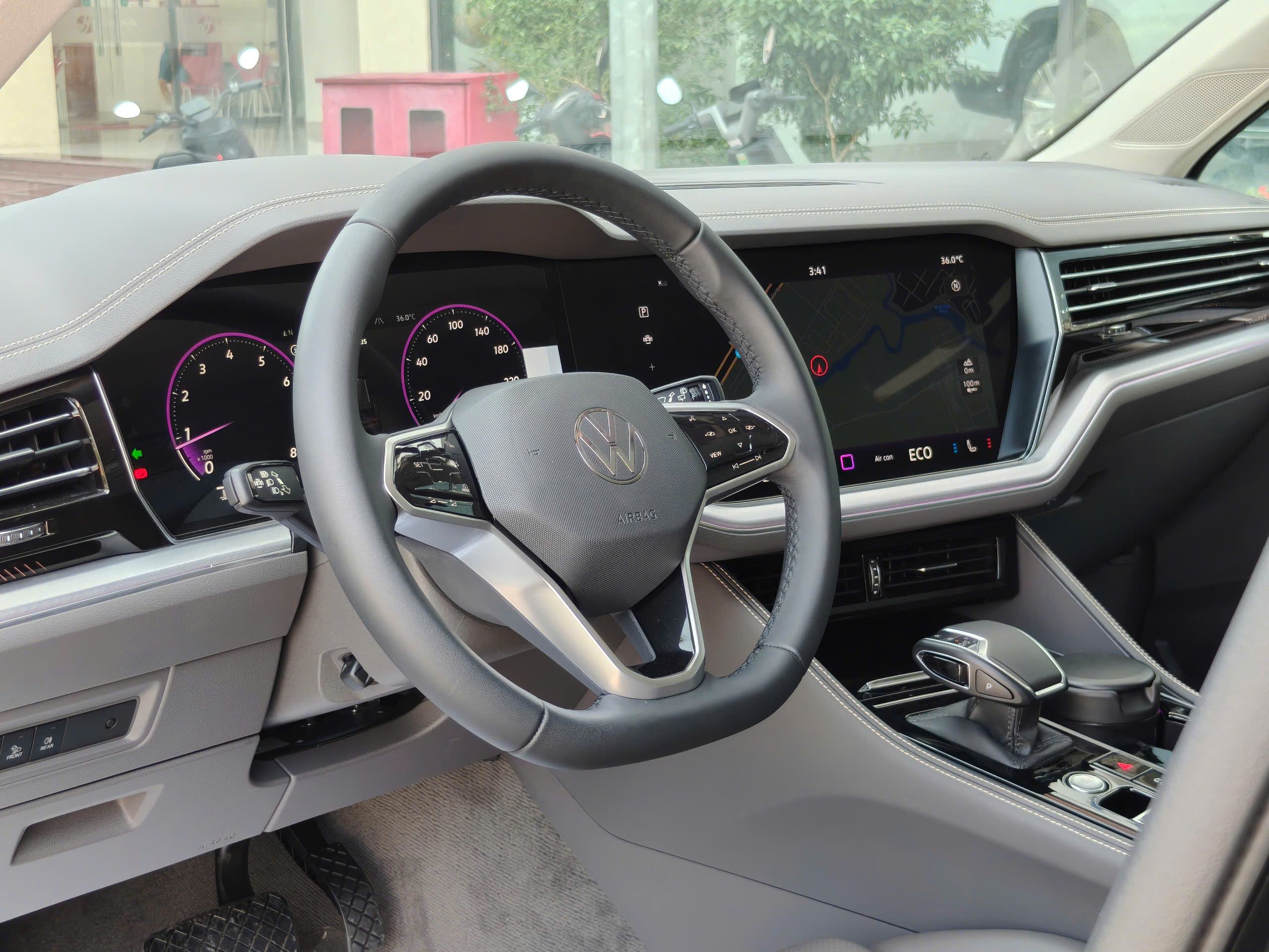 Steering wheel and digital instrument cluster inside a modern car.