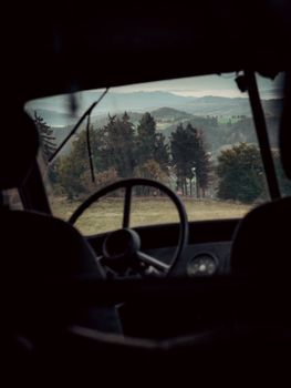 View of Lower Silesian landscape through the window of a vintage vehicle, highlighting nature's beauty.