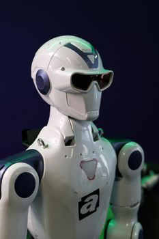 A sleek, modern robot showcased at a technology expo, illustrating AI advancement.