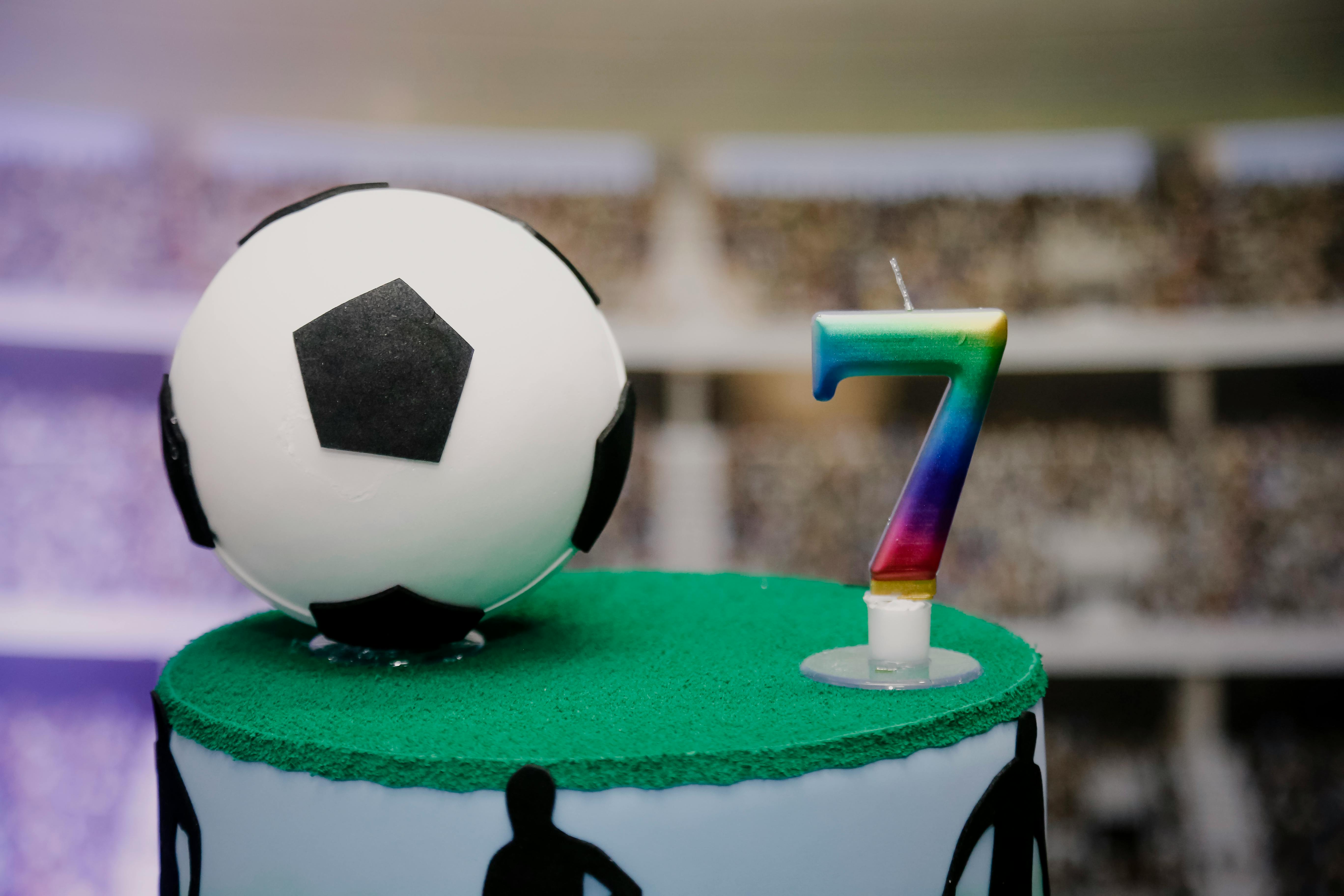 delicious birthday cake with football theme and number candle