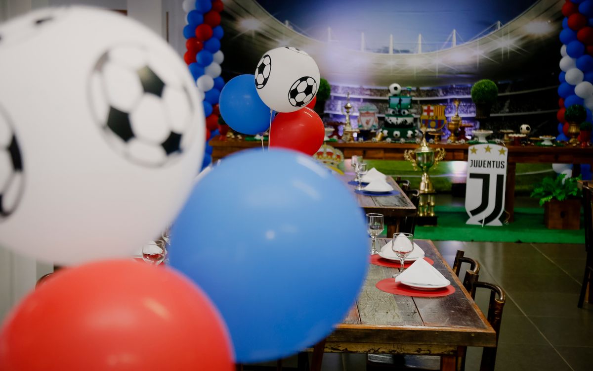 Soccer-themed birthday party setup with colorful balloons and sport-themed table decorations