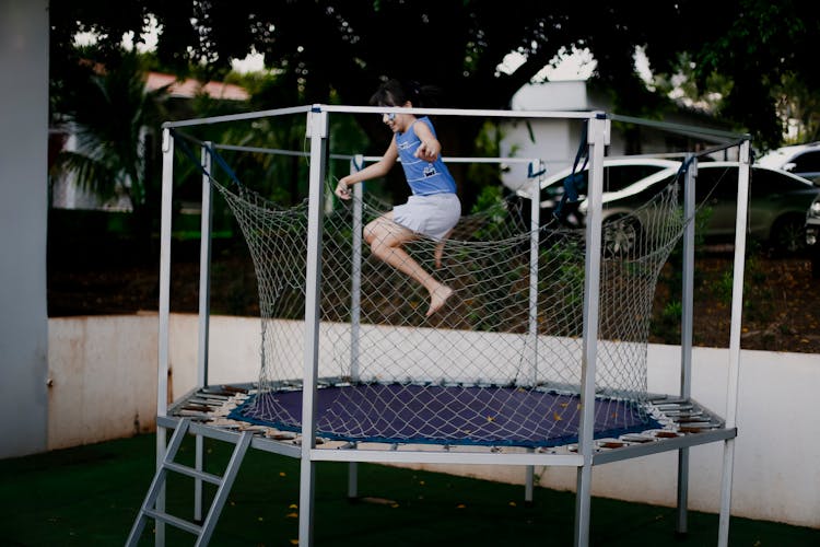 Girl Jumping On A Trampoline