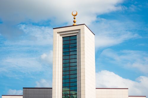 Free A sleek, modern tower with Islamic architecture elements set against a blue sky in Paris. Stock Photo