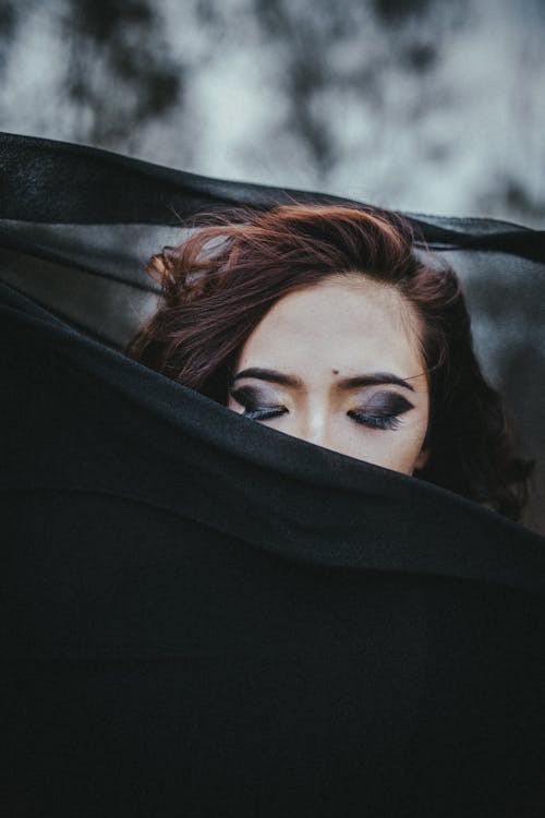 Woman Covering Her Face With Black Textile