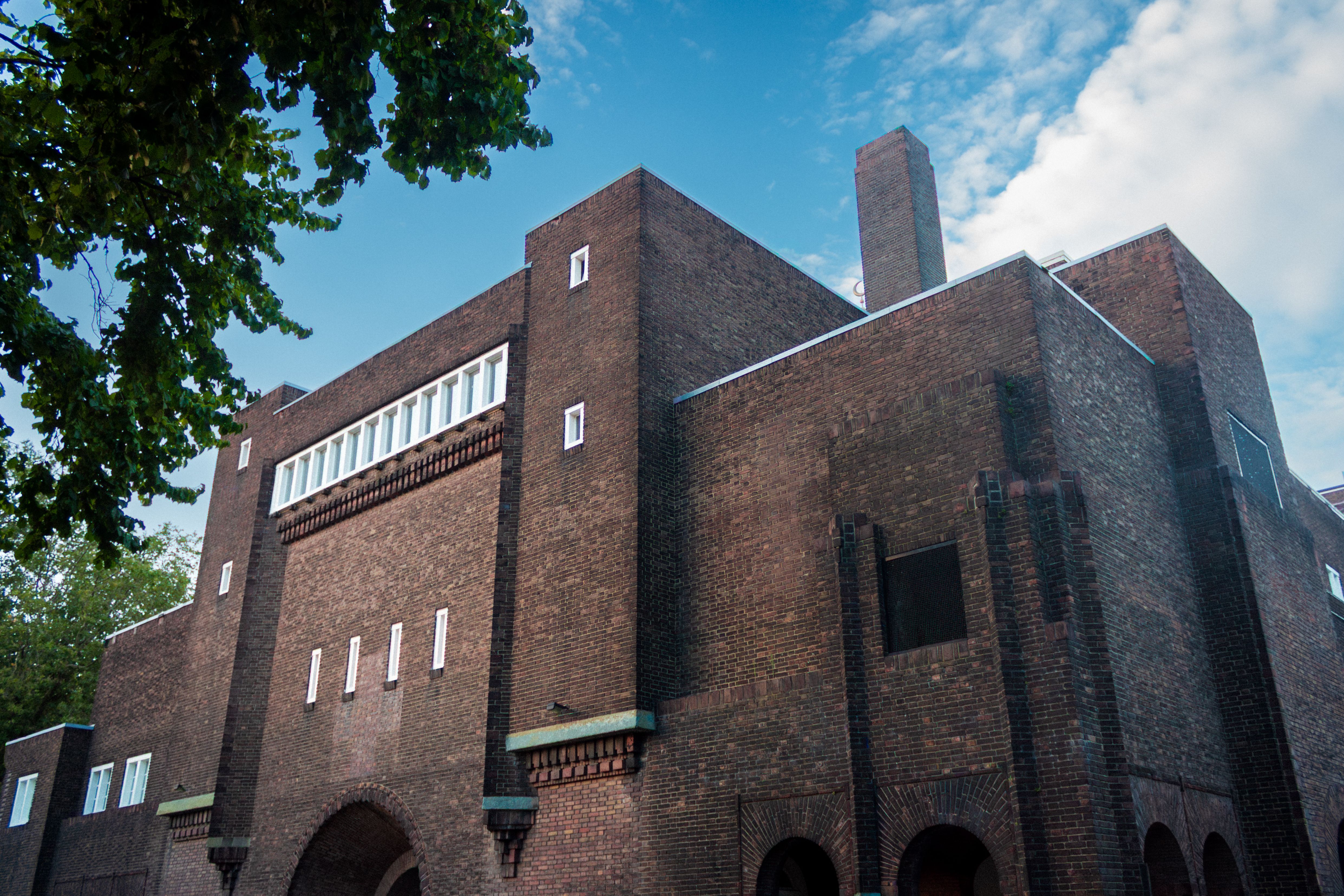 Stunning architectural building in Rotterdam featuring distinctive brick design under a clear sky.