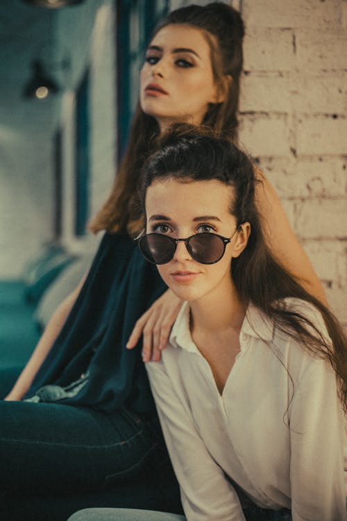 Woman In White Button Up Top And Black Sunglasses 