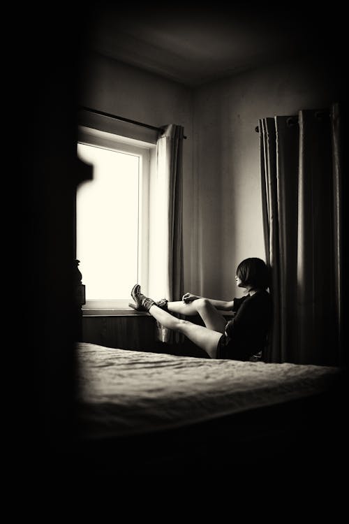 Woman Sitting By The Window
