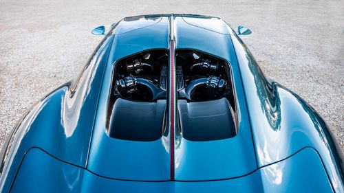 Free Aerial shot of a sleek blue luxury sports car's engine and smooth body. Stock Photo