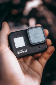 A detailed close-up image of a GoPro camera being held, highlighting its design.