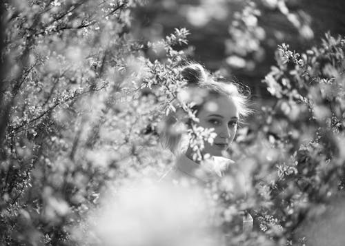 Grayscale Photo Of Woman near Plants