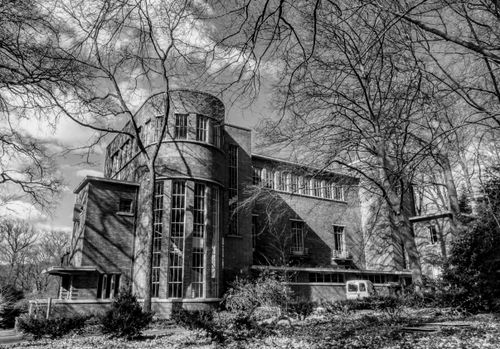 Free Monochrome image of architectural building amidst trees in Arnhem, Netherlands. Stock Photo