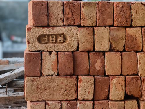 Free Close-up of a stack of red clay bricks with RBF imprint, ideal for construction themes. Stock Photo