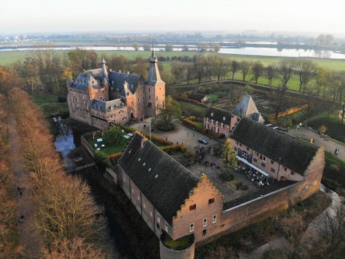 Free Stunning aerial image of Doorwerth Castle surrounded by fall foliage in Gelderland, Netherlands. Stock Photo