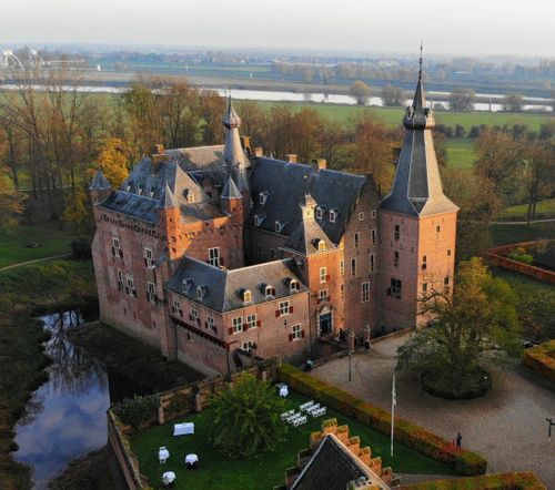 Free Majestic aerial view of medieval Doorwerth Castle surrounded by autumn landscapes in the Netherlands. Stock Photo