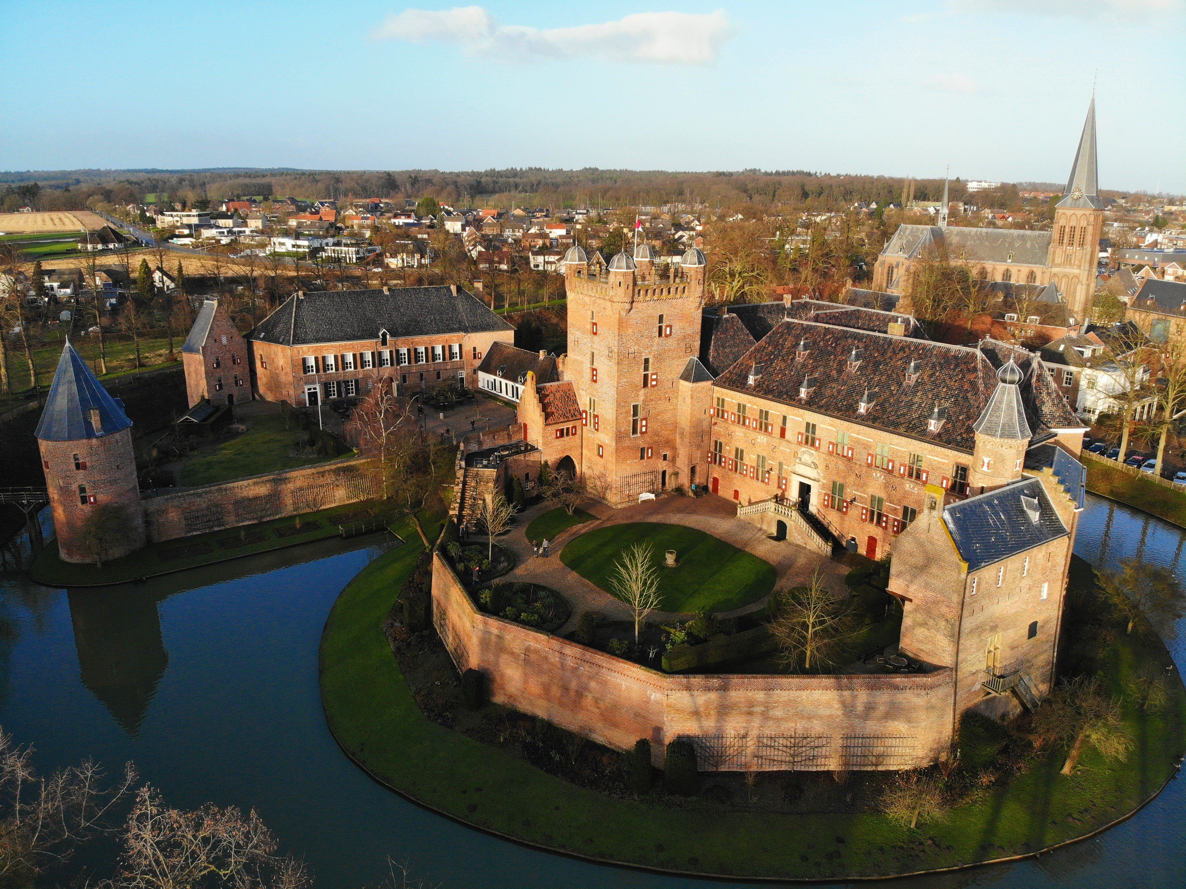 Drone shot of Huis Bergh Castle, surrounded by a moat in 's-Heerenberg, Gelderland, Netherlands.