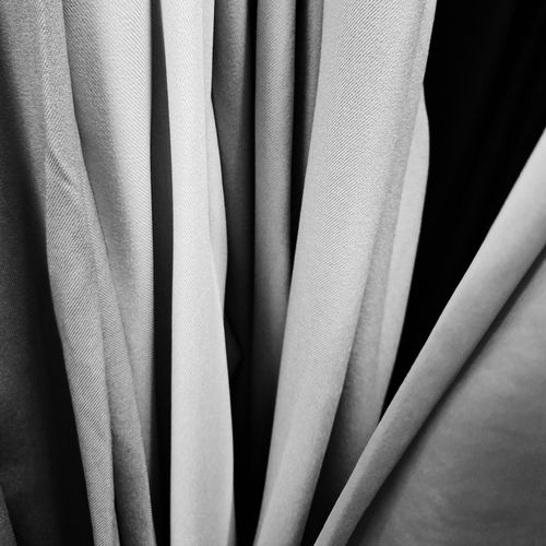 Free Monochromatic abstract image of fabric drapery folds, showcasing texture and light play. Stock Photo