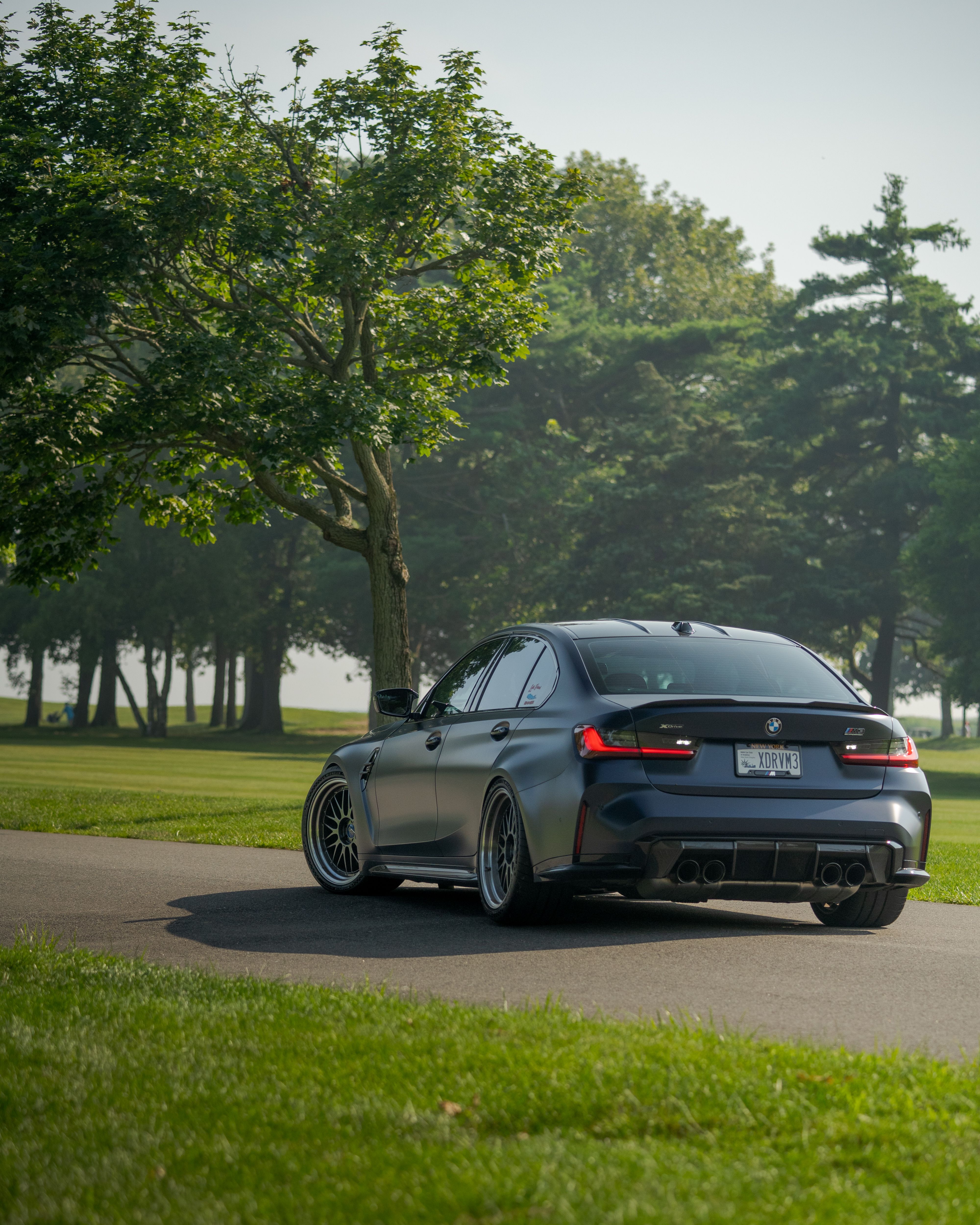 Sleek Luxury Car on Scenic Road · Free Stock Photo