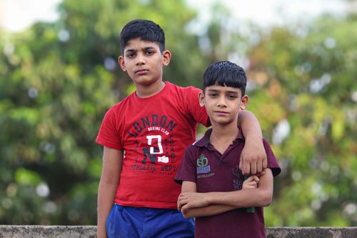 Free Two young boys standing closely outdoors in Jaipur, India, during daytime. Stock Photo