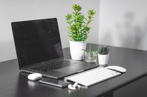 Free Laptop Computer Beside White Apple Magic Keyboard And Magic Mouse Stock Photo