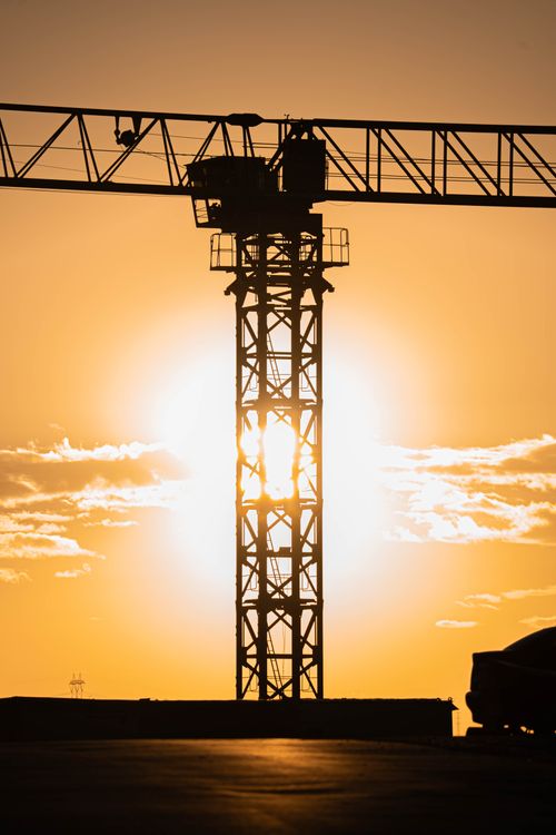 Free A construction crane silhouetted against a vibrant sunset in Gölbaşı, Ankara. Stock Photo