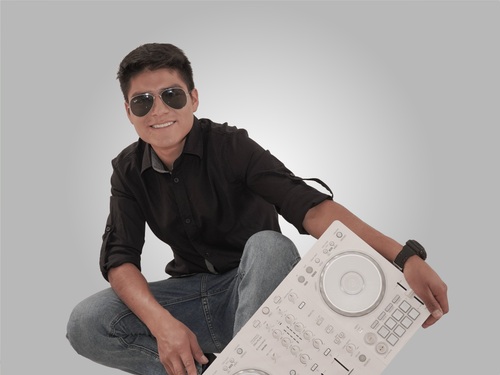 Free Young male DJ smiling with equipment against a neutral background. Stock Photo