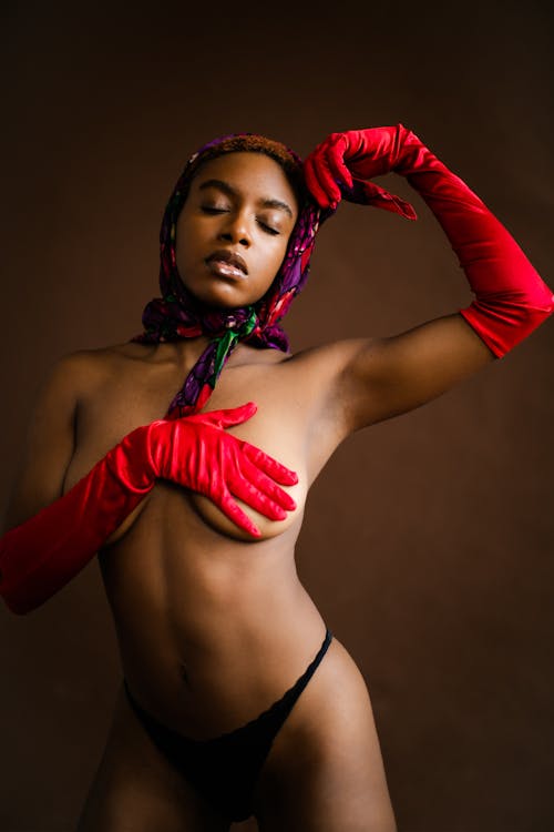 Free Woman in Black Bikini Top and Red Gloves Stock Photo