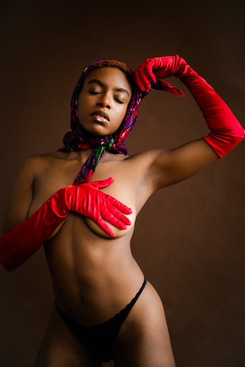 Woman in Black Bikini Top and Red Gloves