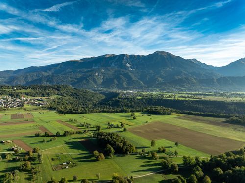 Free A breathtaking aerial view of Bled Valley with lush fields and majestic mountains in Slovenia. Stock Photo