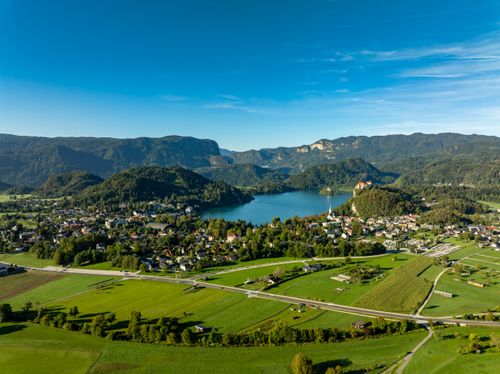 Free Breathtaking aerial view of Lake Bled and surrounding landscapes in Slovenia, captured on a sunny day. Stock Photo