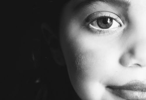 Free Artistic black and white close-up of a child's face capturing innocence and emotion. Stock Photo