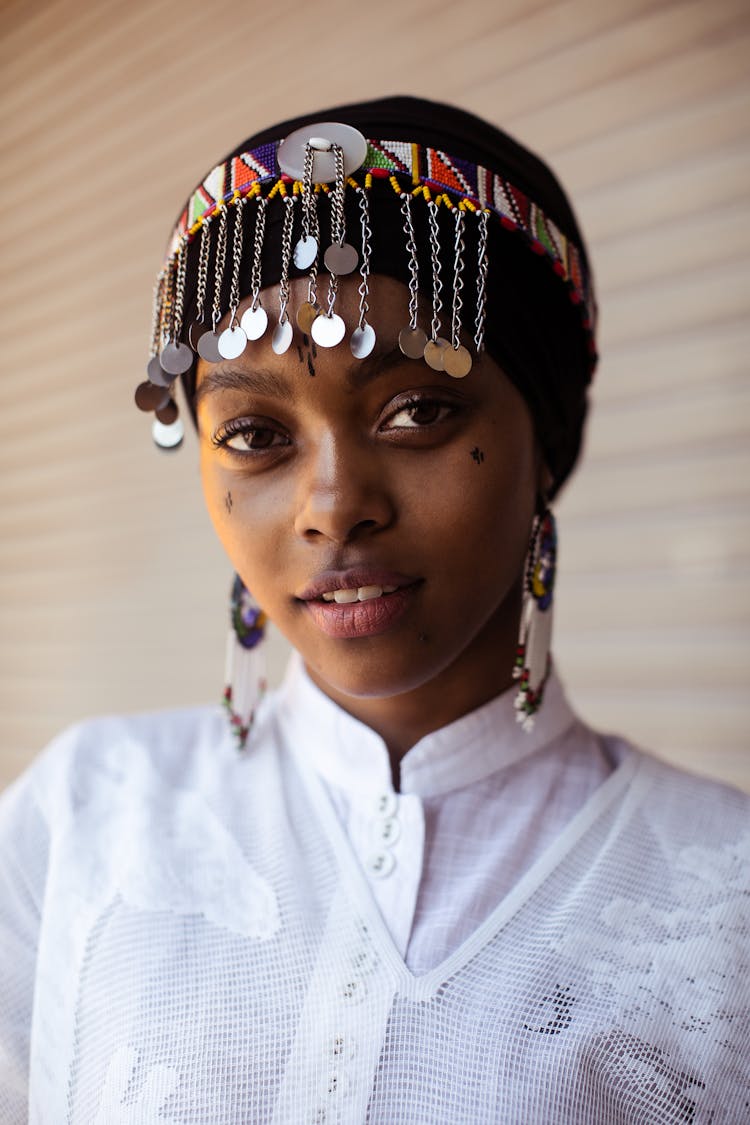 Woman In White Button Up Shirt Wearing Headdress